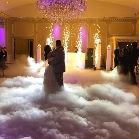 couple dances on clouds with dj in background